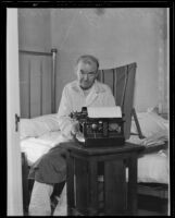 Author John Wiley seated on his bed as he types, 1935