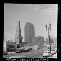 Street scene with Standard Oil Co. oil derrick stands with construction on Occidental Building in Los Angeles, Calif., 1964