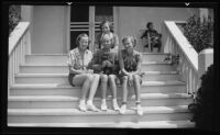 UCLA sorority Gamma Phi Beta members posing on steps with dog, [Los Angeles?], 1936