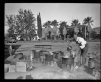 Man at work in a field kitchen for survivors and/or aid workers after the Saint Francis Dam failure and resulting flood, Santa Clara River Valley, 1928