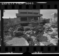 Kate Kunitsugu standing in garden of Japanese American Cultural and Community Center in Los Angeles, Calif., 1980