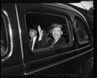 Robert S. James, suspect in Mary Emma James murder case, waving from car window, 1935 or 1936