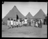 Group portrait of children outside tents after the flood resulting from the failure of the Saint Francis Dam, Santa Clara River Valley (Calif.), 1928