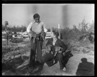 Two unidentified young men with piglets, Los Angeles County, 1935