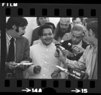 Shri Sant Ji Maharaj (Prem Rawat) surrounded by reporters upon arrival in Los Angeles, Calif., 1972