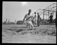 Athlete lands during the broad jump competition at the Pacific Fleet championship track meet, Long Beach, 1922