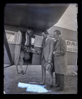 Pilot Paul E. Richter Jr. handing over first piece of freight delivered by air from Europe, Los Angeles, 1928