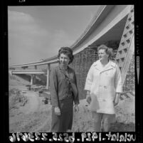 Civil engineers Marilyn Reece and Carol Schumaker standing next to the Reece designed Santa Monica - San Diego interchange, 1964