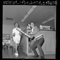 Minh Son Nguyen playing baseball with therapist Edith Gillespie at Orthopaedic Hospital in Los Angeles, Calif., 1966