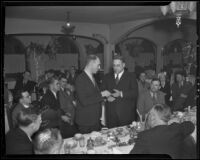 Lieut. C. J. Dickinson presents pistol and belt to Chief James E. Davis, Los Angeles, 1936