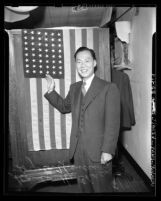 Stanley Chan (Chan Shau Hong) standing before United States flag at his naturalization ceremony in Los Angeles, Calif., 1944