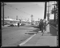 Streetcars stand idle at MTA yard as pickets with placards attesting strike in Los Angeles, Calif. ,1960