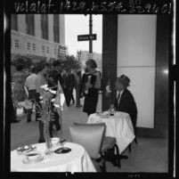 Two female musicians entertaining passersby in front of Los Angeles office of Air France on Bastille Day, 1965