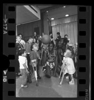 Harlem Globetrotters Harrison Stepter and Bob "Zorro" Hunter entertaining children at Los Angeles' Orthopaedic Hospital, 1970