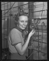 Nancy Nolen poses with chemistry equipment, Los Angeles, 1935