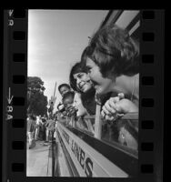 Teenagers, bound for democracy camp, poking their heads out windows of bus in Los Angeles, Calif., 1966