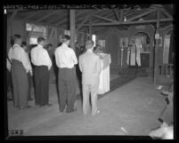 Russian Orthodox Priest conducting services for refugees housed by Quakers in Ontario, Calif., 1950