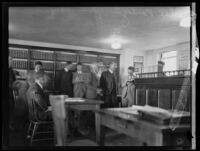 Alexander Pantages in courtroom with other men during his trial, Los Angeles, 1929