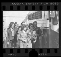 William and Emily Harris, manacled and being escorted to bus by sheriffs in Los Angeles, Calif., 1976