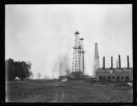 Oil well fire erupts in middle of oil field, Santa Fe Springs, 1935