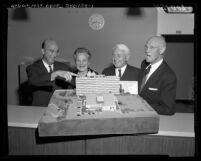 Clark Kerr, Lillian Dykstra, Donald H. McLaughlin, and Vern O. Knudsen viewing model of UCLA's Dykstra Dormitory, 1959