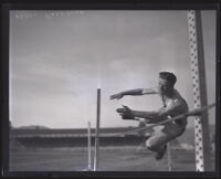 Frank Bradshaw, Occidental College athlete, completing the high jump, Los Angeles