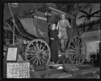 Two women pose on the Ontario display at the National Orange Show, San Bernardino, 1933