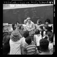 Myra Cohn Livingston, poet-in-residence of Beverly Hills School District, talking with group of students, Calif., 1973