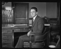 Man seated at a desk during the Kid McCoy murder trial, Los Angeles, 1924