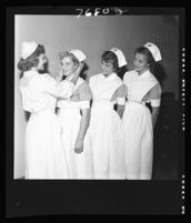 Mary Eilers, Mary Mayes, Santa Solomonian, and Janet Horsh at a nurse capping ceremony, Good Samaritan Hospital, Los Angeles, 1952