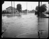 Storm-flooded intersection of 47th and Figueroa, Los Angeles, [circa 1927-1939]