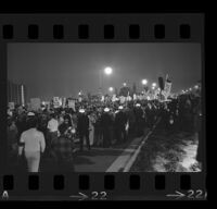 Police stand in line against protesters at Century Plaza during President Johnson's visit, 1967