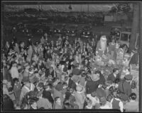 Santa Claus (Edward Shaffer) givess out Christmas presents to children at the Wilshire Council P.T.A.'s Christmas party, Los Angeles, 1935