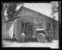 Child in front of building in "doomed" town Prado, California