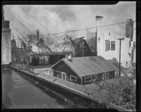 Man on roof observes First Baptist Church of Hollywood ablaze, Hollywood, 1935