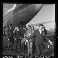 Dave Clark Five band members disembarking plane at Los Angeles International Airport, 1964