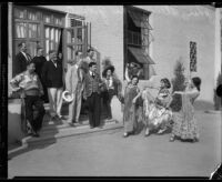 John S. McGroarty watches performers in Spanish style costumes, Southern California, 1920-1940