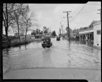 Rain-flooded street, Compton, [1927?]