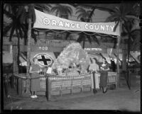 Frances Lee Bussey, Phyllis Cox, and Elinor Brown next to a display of Borabora Island, San Bernardino, 1936