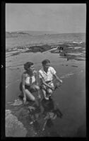 Mrs. John Gunnerson and Mrs. Lois Earl kneeling in tidepools, Laguna Beach, 1936