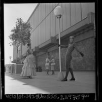 Women modeling dresses from early 1900s to a dress designed for the year 2000 at Assistance League benefit in Los Angeles, Calif., 1965