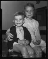 Young siblings David Tingler and Lovina Tingler sit on top of a desk, Los Angeles, 1935