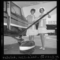 Wearing matching dresses, pilots Virginia Rainwater and Mrs. Alfred Tucker review route for the All-Woman Transcontinental Air Race, Calif., 1970