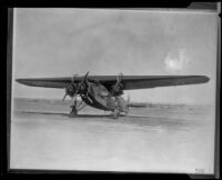 Fokker tri-engined airplane sits in a field, [Los Angeles?], 1927