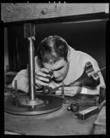 Raymond Laborda closely examines a precious gem, Los Angeles, 1936