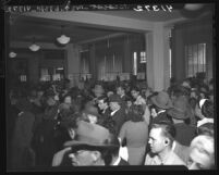 Lines of people waiting to collect their checks at unemployment office in Los Angeles, Calif., 1946