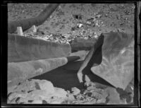 Close-up of a blast-damaged section of pipe along the Los Angeles Aqueduct in No-Name Canyon, Inyo County vicinity, [about 1927]