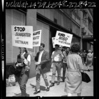 Students for a Democratic Society members wearing gas masks, picketing Armed Forces induction station in Los Angeles, Calif., 1965