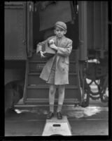 Child actor Jackie Kelk and his kitten arrive by train to Los Angeles, Los Angeles, 1933