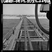 Construction Venice Beach pier; view from ocean looking towards the beach, Calif., 1964